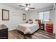 Cozy bedroom with striped bedding and wood flooring at 38100 W Santa Clara Ave, Maricopa, AZ 85138