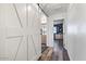 Hallway with barn door and wood flooring at 38100 W Santa Clara Ave, Maricopa, AZ 85138