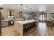 Modern kitchen boasts a large island, stainless steel appliances, and hardwood floors at 38100 W Santa Clara Ave, Maricopa, AZ 85138