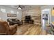 Cozy living room with a rustic wood accent wall and comfortable seating at 38100 W Santa Clara Ave, Maricopa, AZ 85138