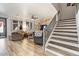 Spacious living room with wood-look floors, and a staircase at 38100 W Santa Clara Ave, Maricopa, AZ 85138