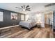 Spacious main bedroom with wood-look floors and an accent wall at 38100 W Santa Clara Ave, Maricopa, AZ 85138