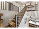 Upper level stairs with wood treads and grey railing at 38100 W Santa Clara Ave, Maricopa, AZ 85138