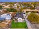 Stunning aerial view of a charming two-story home with lush lawn, black roof and detached garage at 412 W Vermont W Ave, Phoenix, AZ 85013