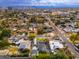 Expansive aerial shot of a neighborhood showing a home with mature landscaping and a city skyline view at 412 W Vermont W Ave, Phoenix, AZ 85013