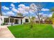 Landscaped backyard features a well-maintained lawn, offering an inviting outdoor space for relaxation and recreation at 412 W Vermont W Ave, Phoenix, AZ 85013
