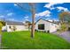 Expansive backyard featuring manicured grass, mature trees, and tasteful landscaping with a detached garage at 412 W Vermont W Ave, Phoenix, AZ 85013