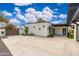 Modern home showcasing a spacious concrete patio and manicured yard with lush landscaping beneath a beautiful blue sky at 412 W Vermont W Ave, Phoenix, AZ 85013