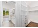 Bathroom with double vanity leading to an ample closet with drawer and shelf space at 412 W Vermont W Ave, Phoenix, AZ 85013