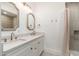 Bathroom with double sinks and white vanity cabinets at 412 W Vermont W Ave, Phoenix, AZ 85013