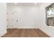 A bedroom with hardwood floors, white walls, black door hardware, and natural light from windows at 412 W Vermont W Ave, Phoenix, AZ 85013