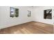 Bright bedroom with hardwood floors, white walls, and natural light from three windows at 412 W Vermont W Ave, Phoenix, AZ 85013
