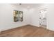 A bedroom with hardwood floors, white walls, black door hardware, and natural light from windows at 412 W Vermont W Ave, Phoenix, AZ 85013