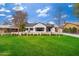 Charming home with a manicured front lawn, white brick exterior, and black shutters under a blue sky at 412 W Vermont W Ave, Phoenix, AZ 85013