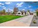 Beautiful home with a manicured lawn, white brick, black shutters, and extended driveway leading to a garage at 412 W Vermont W Ave, Phoenix, AZ 85013