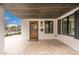 Cozy front porch featuring a wooden door, black-trimmed windows, and a dark wood ceiling at 412 W Vermont W Ave, Phoenix, AZ 85013