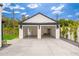 Two-car garage with modern black pergola, an epoxy floor, and ample space for vehicles and storage at 412 W Vermont W Ave, Phoenix, AZ 85013