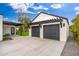 Spacious two-car garage exterior featuring black doors, a pergola, and concrete driveway at 412 W Vermont W Ave, Phoenix, AZ 85013