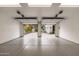 Well-lit two-car garage with epoxy floors, white walls, and open doors providing great access to the outdoors at 412 W Vermont W Ave, Phoenix, AZ 85013