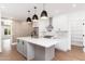 Modern kitchen with white cabinets, center island, and stainless steel appliances at 412 W Vermont W Ave, Phoenix, AZ 85013