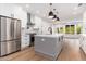 Kitchen with stainless steel appliances, center island, and white cabinets at 412 W Vermont W Ave, Phoenix, AZ 85013