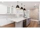 Stylish kitchen with white cabinets, center island, and modern pendant lighting at 412 W Vermont W Ave, Phoenix, AZ 85013