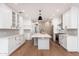 Modern kitchen with white cabinets, center island, and stainless steel appliances at 412 W Vermont W Ave, Phoenix, AZ 85013