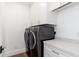 Bright laundry room with front-load washer and dryer and white quartz countertop at 412 W Vermont W Ave, Phoenix, AZ 85013