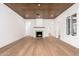 Bright living room featuring wood floors, light walls, a fireplace, stylish wood ceiling, and open doorways at 412 W Vermont W Ave, Phoenix, AZ 85013