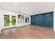 Bright living room with white walls, wood floors, and a blue paneled accent wall at 412 W Vermont W Ave, Phoenix, AZ 85013