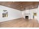Spacious living room with hardwood floors, fireplace, and wood plank ceiling at 412 W Vermont W Ave, Phoenix, AZ 85013
