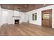 Bright living room features a fireplace, wood floors, light walls, a stylish wood ceiling, and open doorways at 412 W Vermont W Ave, Phoenix, AZ 85013