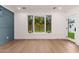 Living room with hardwood floors, paneled wall, and ample natural light at 412 W Vermont W Ave, Phoenix, AZ 85013