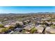 Aerial view of a desert community showcasing its well-maintained streets, native plants, and distant mountain views at 41216 N Shadow Creek Ct, Anthem, AZ 85086