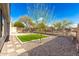 Private backyard featuring artificial turf, desert landscaping, and wrought iron fence at 41216 N Shadow Creek Ct, Anthem, AZ 85086