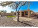 Backyard featuring a covered patio, gravel landscaping, and an artificial grass area at 41216 N Shadow Creek Ct, Anthem, AZ 85086