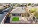 Aerial view of a private backyard featuring synthetic grass, stone pavers, and a secure wrought iron fence at 41216 N Shadow Creek Ct, Anthem, AZ 85086