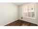 Cozy bedroom with shuttered window providing natural light and wood flooring at 41216 N Shadow Creek Ct, Anthem, AZ 85086