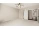 Bright and airy bedroom with neutral carpet and a ceiling fan with access to the en-suite bathroom at 41216 N Shadow Creek Ct, Anthem, AZ 85086