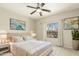 Comfortable bedroom with a ceiling fan, large window with outdoor view, and modern decor at 41216 N Shadow Creek Ct, Anthem, AZ 85086