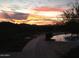 Stunning sunset view from the community pool area showcasing serene mountain views and colorful sky at 41216 N Shadow Creek Ct, Anthem, AZ 85086