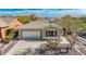 Charming home featuring a tile roof, desert landscaping, and a two car garage at 41216 N Shadow Creek Ct, Anthem, AZ 85086