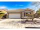Charming single-story home featuring a two-car garage, desert landscaping, and a neutral color scheme at 41216 N Shadow Creek Ct, Anthem, AZ 85086