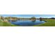 Panoramic view of the golf course featuring a pond, waterfall, and lush green fairways at 41216 N Shadow Creek Ct, Anthem, AZ 85086