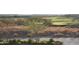 Elevated view of a beautiful golf course winding through a desert landscape with scattered trees and vegetation at 41216 N Shadow Creek Ct, Anthem, AZ 85086