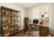 Well-lit home office with custom shelving, a comfortable desk, and a cozy atmosphere for productivity at 41216 N Shadow Creek Ct, Anthem, AZ 85086