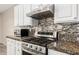 Modern kitchen features stainless steel appliances, decorative backsplash, and granite countertops at 41216 N Shadow Creek Ct, Anthem, AZ 85086