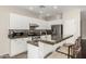 Well-lit kitchen with a breakfast bar, granite countertops, and stainless steel appliances at 41216 N Shadow Creek Ct, Anthem, AZ 85086