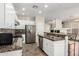 Updated kitchen with stainless steel appliances, granite countertops, and a breakfast bar at 41216 N Shadow Creek Ct, Anthem, AZ 85086
