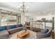 Open-concept living area with hardwood floors, a modern kitchen, and a comfortable seating area with natural light at 41216 N Shadow Creek Ct, Anthem, AZ 85086